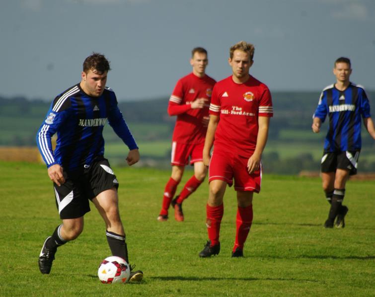 Ryan Mansell presses forward for Hakin United, to his right is Jordan Richards who scored the winner for West Dragons